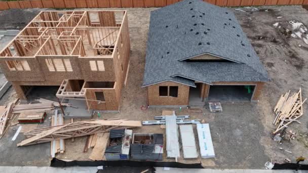 Panning Aerial Shot Three Homes Different Stages Construction — Stock videók