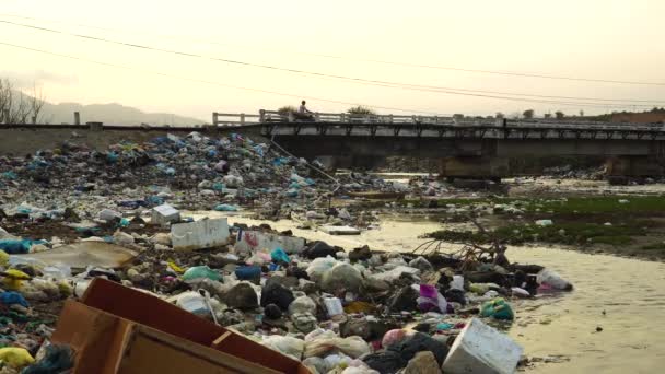 Garbage Piled River Banks Motorbikes Pass Bridge Vietnam Static — Vídeo de Stock