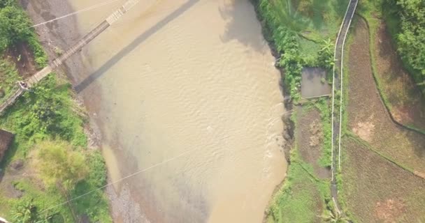 Overhead Drone Shot Suspension Bridge River Motorcycle Crossing Slightly Foggy — Stockvideo