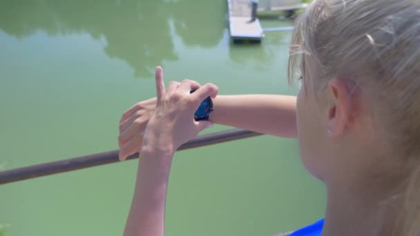 Young Blonde Woman Clicks Scrolls Her Connected Watch Bridge River — Stok video