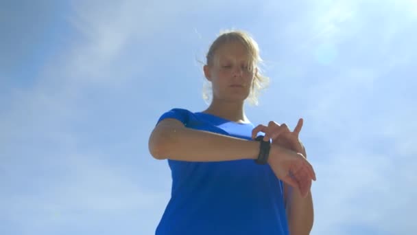 Low Angle Shot Blonde Woman Blue Shirt Using Her Connected — Vídeos de Stock