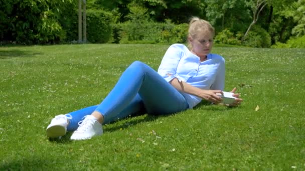 Young Blonde Caucasian Woman Dressed Light Blue White Trainers Lying — Stock Video