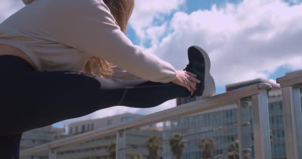 Static Low Angle Shot Woman Stretching Legs Outdoors Shallow Focus — Vídeo de Stock
