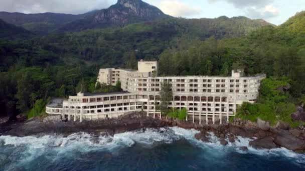 Aerial Dolly Abandoned Mahe Beach Hotel Waves Crashing Rocks Seychelles — 图库视频影像