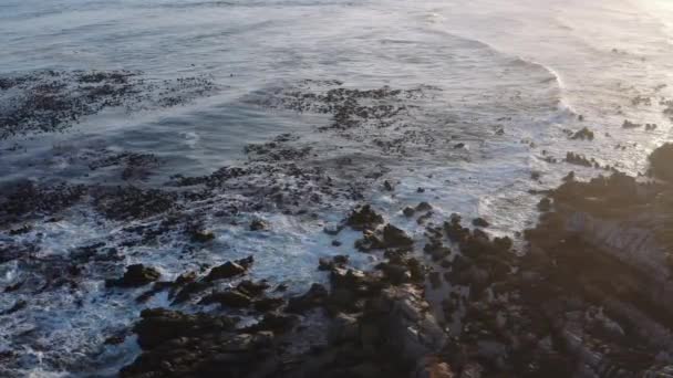 Aerial Overhead Shot Waves Breaking Rocky Seaside Shore Sunset Slowly — Stockvideo