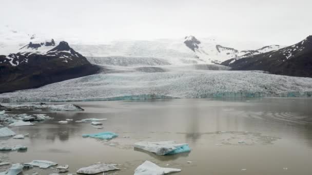 Glacier Iceland Chunks Blue Ice Water Drone Video Pulling Out — Stockvideo