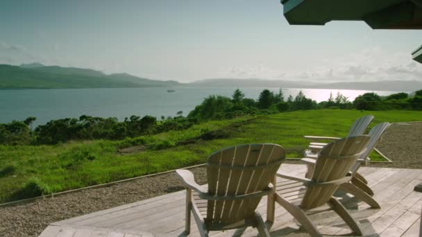 Slider Tracking Shot Deck Chairs Facing Sound Mull Scotland — Vídeo de Stock