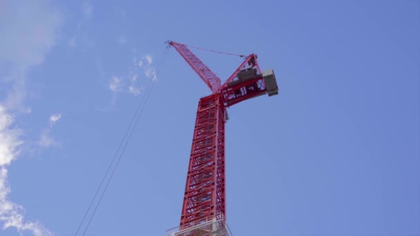Red Construction Crane Arm Looking Clouds Passing Blue Sky — Αρχείο Βίντεο
