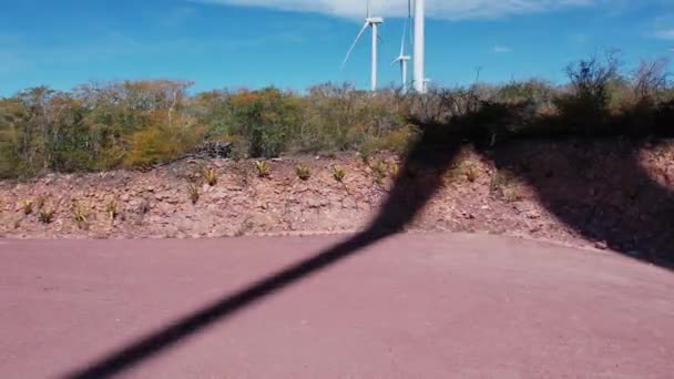 Aerial Truck Shot Wind Turbine Shadows Desert Ground — стоковое видео