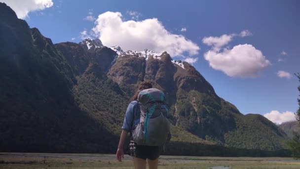 Slider Female Hiker Stretches Mountainous Valley Routeburn Track New Zealand — Stock video
