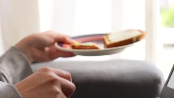 Woman Picking Plate Cheese Toast While Working Home — Stockvideo