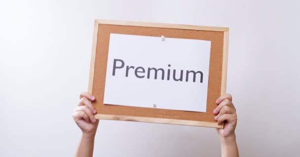 Woman Hand Shows Paper Board Word Premium White Studio Background — Video Stock