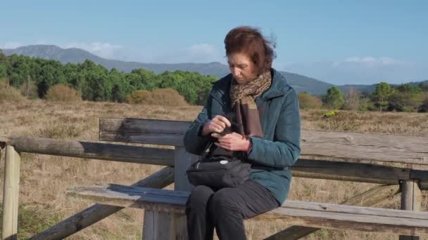 Woman Using Mobile Sitting Wooden Bench Dunes Corrubedo Spain Static — Video Stock