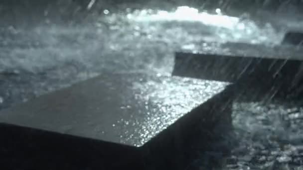 Defocused Fountain Water Falls Granite Block Spectral Drops — Stockvideo