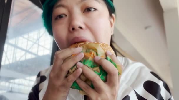 Asian Girl Biting Eating Plant Based Whopper Vegan Burger — Stockvideo