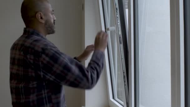 Indian Bald Male Casual Attire Walking Window Close Turing Handle — Stok Video