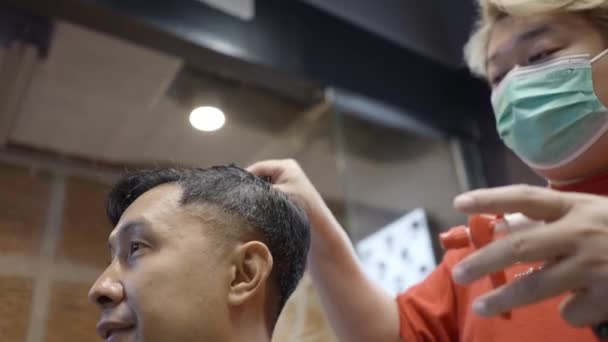 Bottom Shot Barber Wearing Mask Splashes Water Client Hair Haircut — 图库视频影像