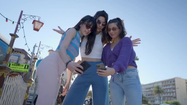 Young Women Sunglasses Take Selfies Phones Ground View — Vídeo de Stock