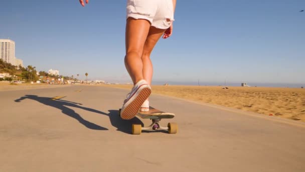 Female Feet Sneakers Pushing While Riding Skateboard Low Angle — Stock videók