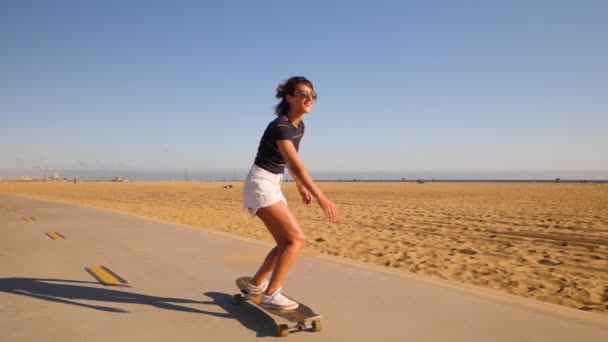 Sporty Young Woman Sunglasses Dancing Spinning While Riding Longboard Beach — Stockvideo