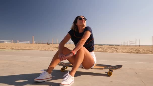 Young Active Woman Sunglasses Sitting Skateboard Skatepark Wide — Stockvideo