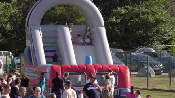 Kids Playing Parental Supervision Inflatable Slide Static — Stock video