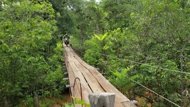 Motorcyclist Crosses Shaky Suspension Bridge Jungle — Stock videók