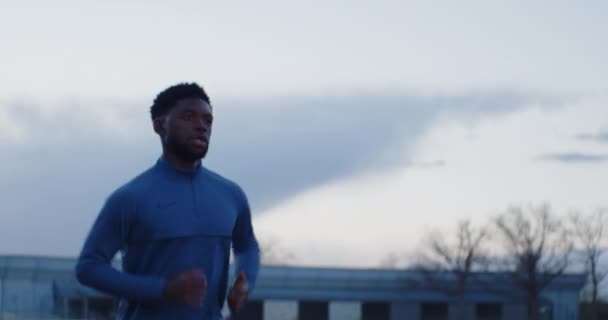 Young Black Male Running Evening Run Wearing Blue Shirt — Stockvideo