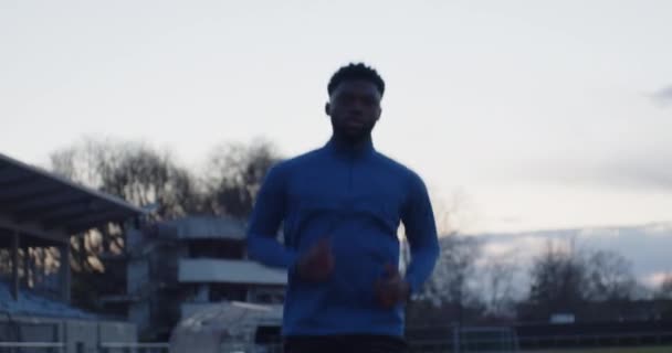 Young Black Male Starting Interval Workout Empty Running Track Blue — Video