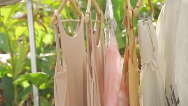 Close Handheld Footage Various Hanging Clothes Shades Brown Placed Wooden — Vídeo de Stock