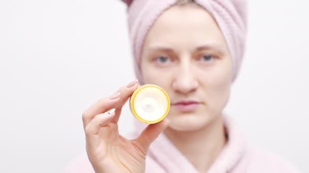 Happy Young Woman Holding Face Lifting Cream Making Funny Faces — Stock video