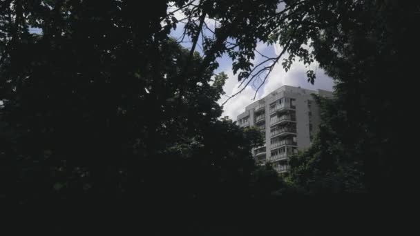 Pan Right Revealing Apartment Building Seen Opening Throw Some Trees — Wideo stockowe