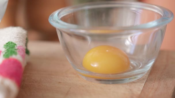Egg Yolk Being Put Glass Bowl Bowl Wooden Cutting Board — Αρχείο Βίντεο