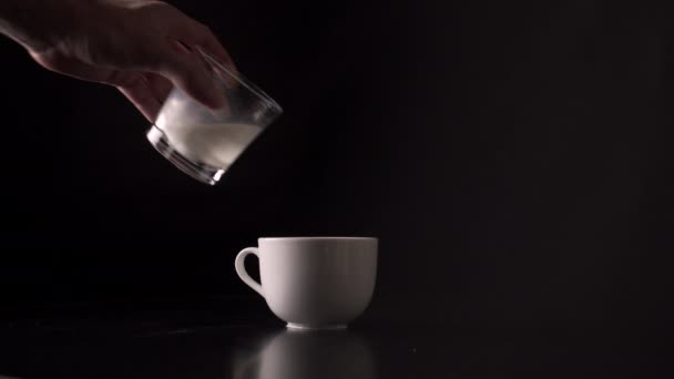 Person Pouring Fresh Milk Cup Coffee Black Background Close — Vídeo de Stock