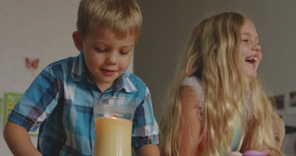 Young Blonde Brother Sister Both Laughing Blowing Out Candle — Stock Video