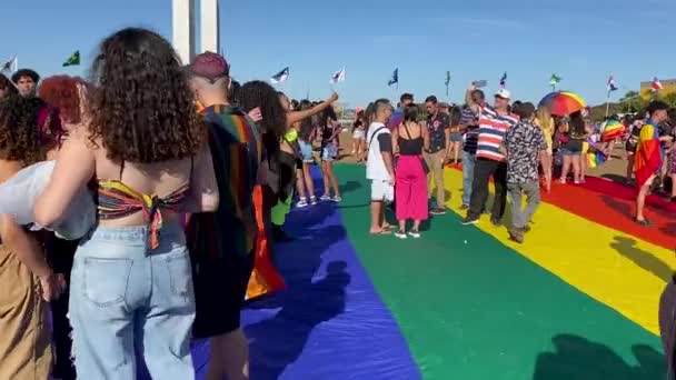 Wide Shot People Walking Colorful Rainbow Flag Covering Ground Gay — Stockvideo