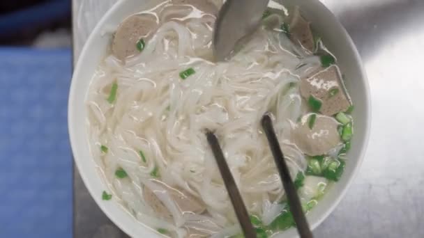 Top Shot Vietnamese Rice Noodle Soup Pho Chopsticks Spoon — Stockvideo