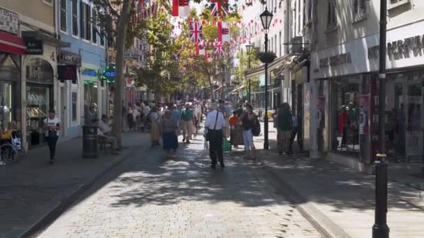 Bustling Gibraltar City Center Street Tourists Trees Flags — Stock Video