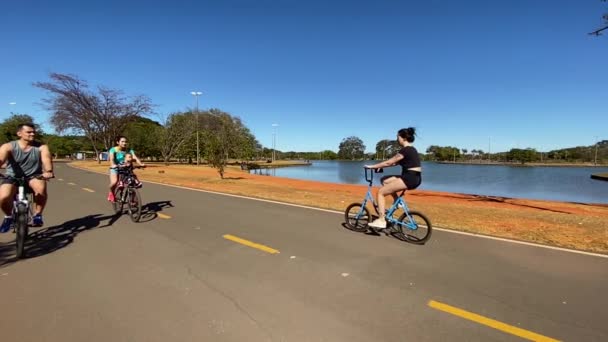 Slow Motion Footage Cyclists Riding One Lakes Brasilia City Park — Stockvideo