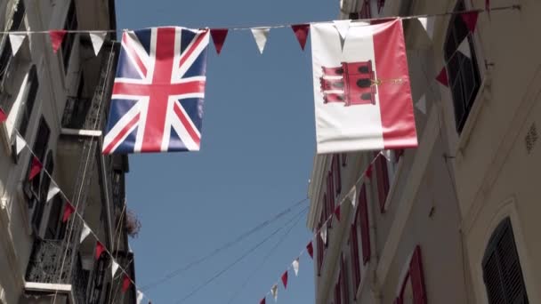 Great Britain Gibraltar Flags Hanging Rope Town Street — Stockvideo