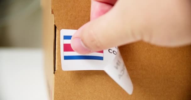 Hands Applying Made Costa Rica Flag Label Shipping Cardboard Box — Vídeos de Stock