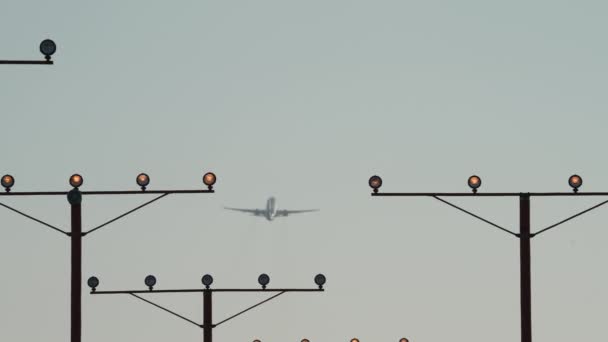 Airliner Climbs Out Takeoff Distance Framed Runway Approach Lights — Vídeos de Stock