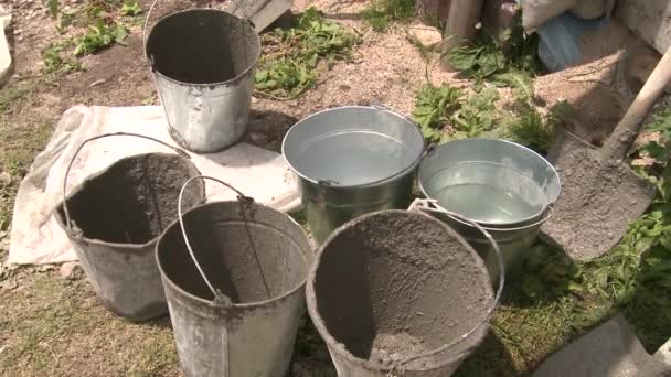 Four Empty Dirty Buckets Mixing Concrete Mortar Shovel One Clean — Stockvideo