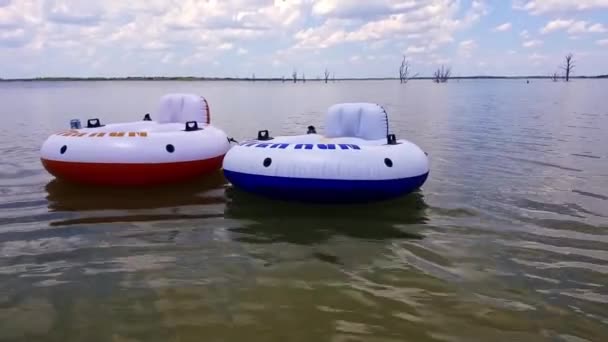 Couple Inner Tubes Floating Lake Waiting Used Close Shot — kuvapankkivideo