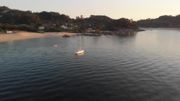 Aerial Orbiting Local Yacht Anchored Calm Seaside Shallows Bueu Beach — Stock video