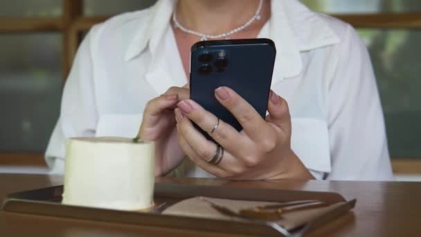 Close Shot Woman Checking Her Phone View Ordered Cake Fork — стокове відео