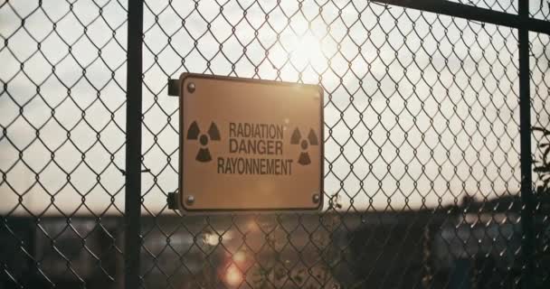 Close Radiation Danger Sign Backlit Sun Barbed Wire Fence Slow — Stockvideo