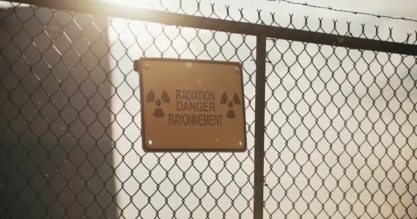 Radiation Danger Sign Barbed Wire Fence Radioactive Particles Backlit Sun — Vídeo de Stock