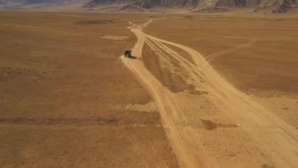 Aerial Dolly Van Driving Steppe Dust Road Mountains Daytime Mongolia — Stock video