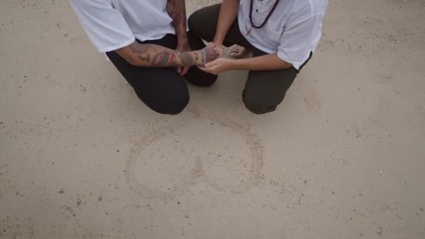 Male Gay Couple Beach Squatting Position Holding Hands Heart Shape — Vídeo de stock